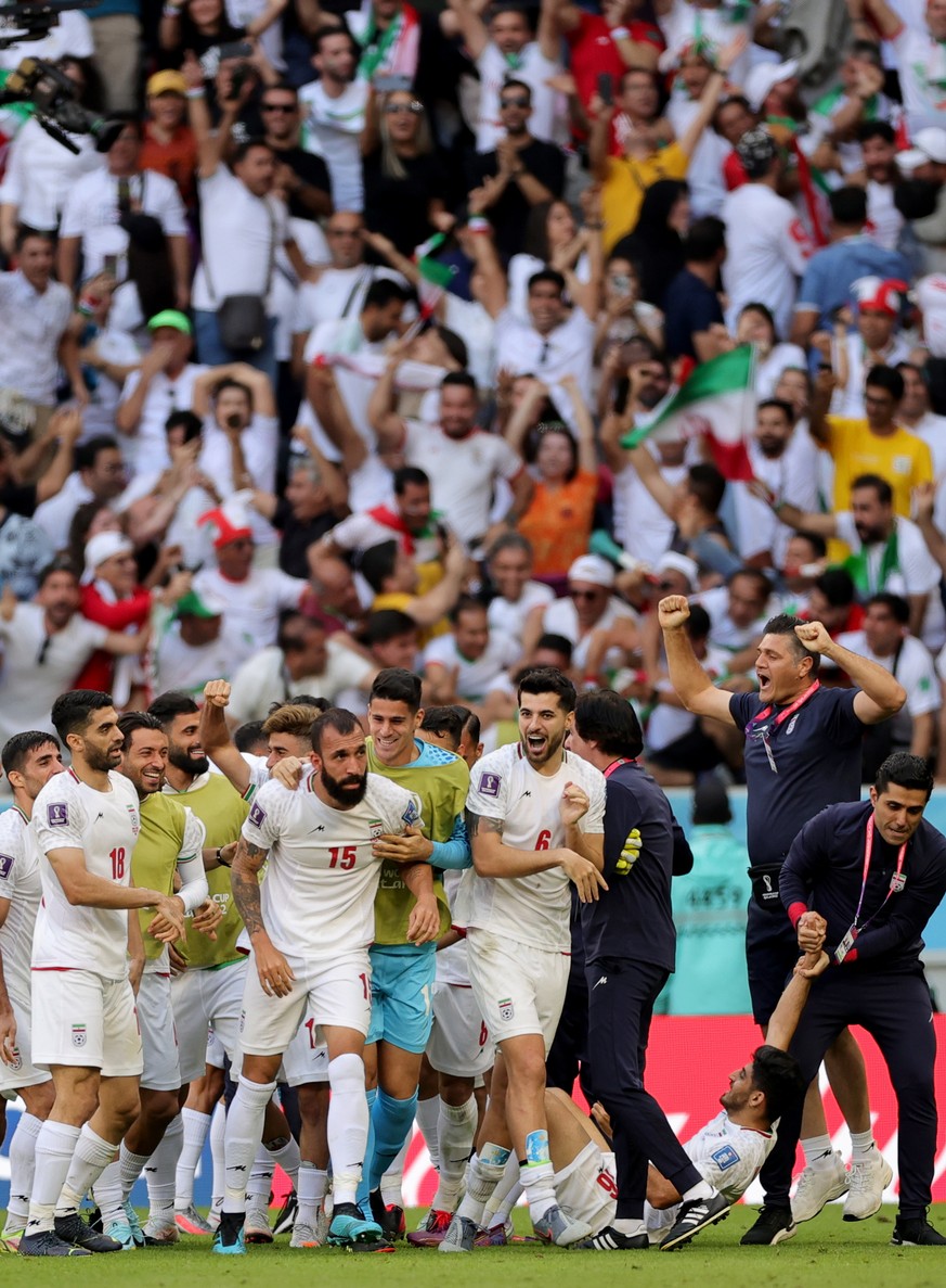 epa10327234 Players of Iran celebrate winning the FIFA World Cup 2022 group B soccer match between Wales and Iran at Ahmad bin Ali Stadium in Doha, Qatar, 25 November 2022. EPA/Friedemann Vogel