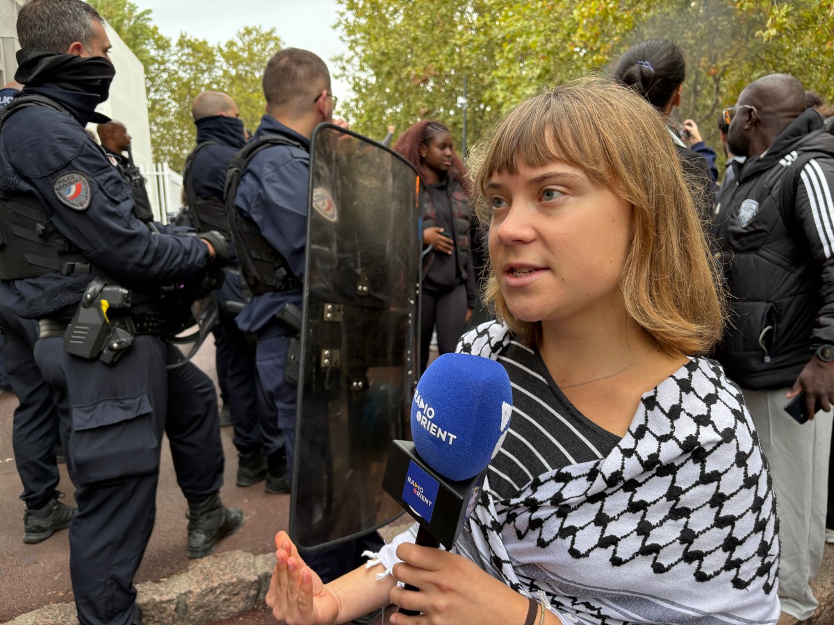 Activist Greta Thunberg answers journalist's questions as she attends a gathering in front of the Paul Eluard high school during a protest against under-resourced schools in Saint-Denis, outside  ...