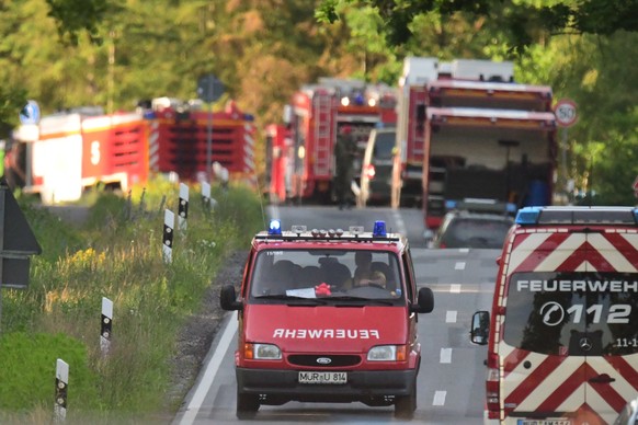 epa07671169 Emergency vehicles stand near the crash site of a Eurofighter Typhoon fighting jet near the village Nossentin in the area of Waren (Mueritz) in Mecklenburg-Western Pomerania, Germany, 24 J ...