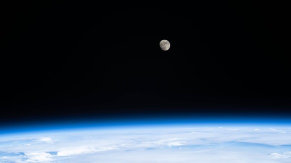 August 10, 2022 - Earth Atmosphere - The waxing gibbous Moon is pictured from the International Space Station as it orbited 259 miles above the Pacific Ocean off the coast of north California. Earth A ...