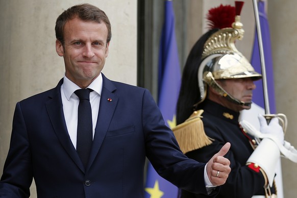 French President Emmanuel Macron gestures as he welcomes President of Azerbaijan Ilham Aliyev prior to their meeting at the presidential Elysee Palace, in Paris, France, Friday, July 20, 2018. A top s ...