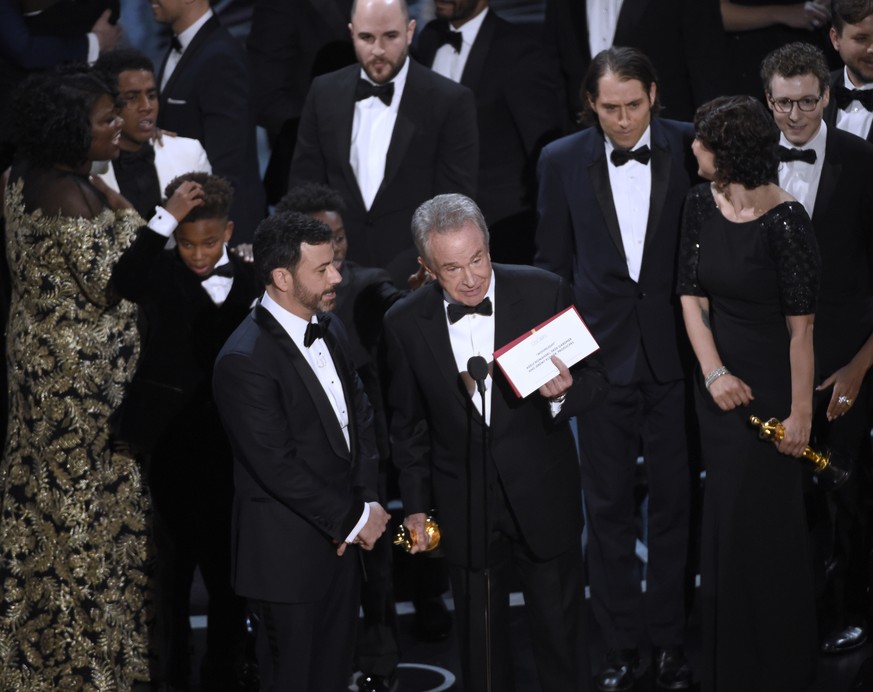 Presenter Warren Beatty shows the envelope with the actual winner for best picture as host Jimmy Kimmel, left, looks on at the Oscars on Sunday, Feb. 26, 2017, at the Dolby Theatre in Los Angeles. The ...