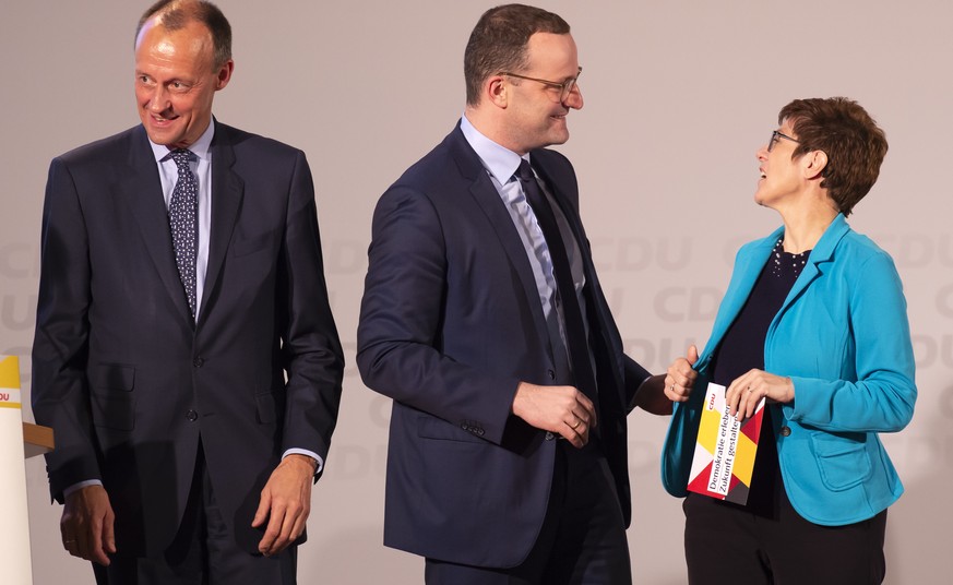 FILE - In this Nov. 21, 2018 file photo Friedrich Merz, former CDU faction leader, left, Germany&#039;s Health Minister Jens Spahn, center, and Annegret Kramp-Karrenbauer, General Secretary of the Ger ...