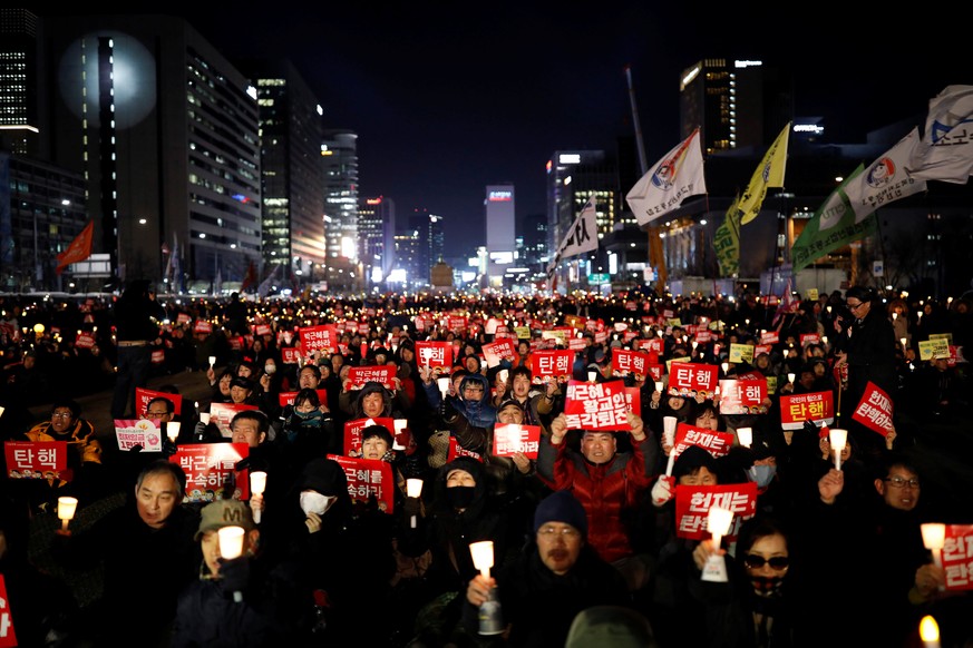 People attend a protest against South Korean President Park Geun-hye, a day before South Korea's Constitutional Court ruling on President Park Geun-hye's impeachment, in Seoul, South Korea, March 9, 2 ...