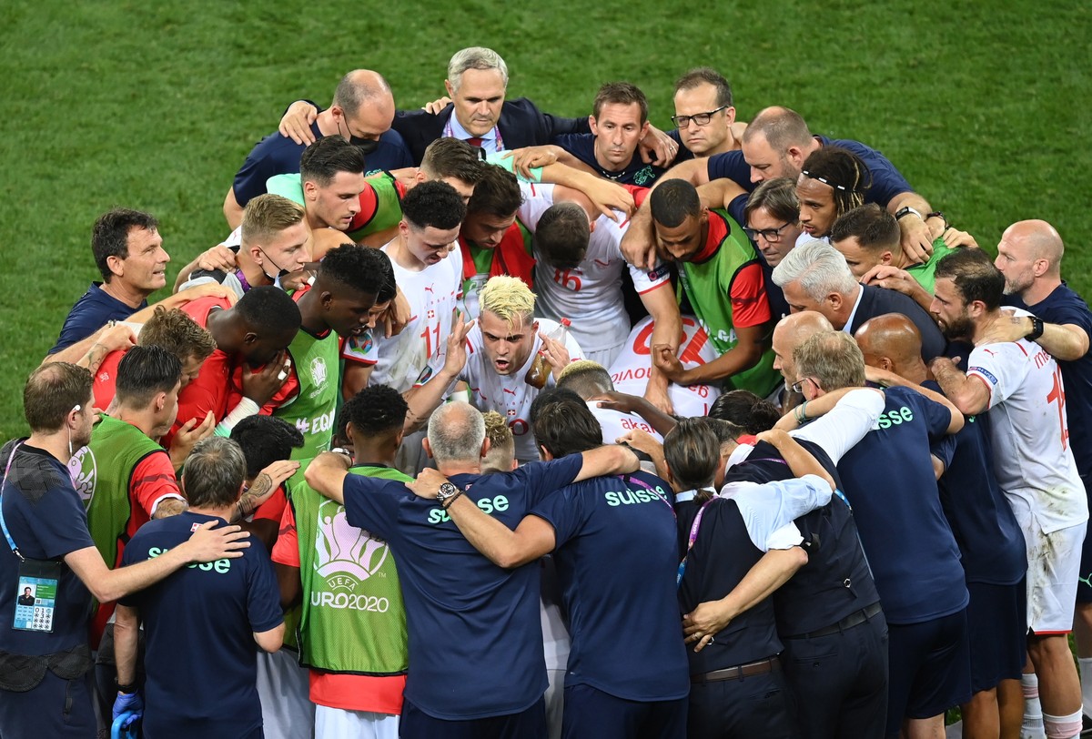 epa09309657 Granit Xhaka of Switzerland (C) talks to his teammates before the penalty shootout during the UEFA EURO 2020 round of 16 soccer match between France and Switzerland in Bucharest, Romania,  ...
