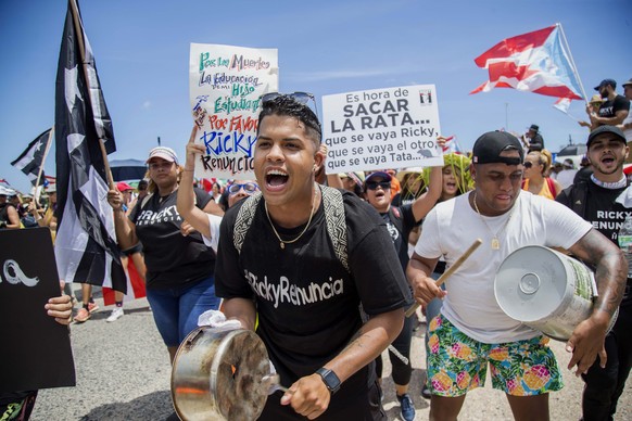 Demonstrators bang on pots and buckets as they march on Las Americas highway demanding the resignation of governor Ricardo Rossello, in San Juan, Puerto Rico, Monday, July 22, 2019. Protesters are dem ...