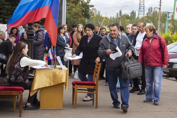 FILE - People line up to vote in a referendum in Luhansk, Luhansk People's Republic controlled by Russia-backed separatists, eastern Ukraine, Sept. 24, 2022. Voting began Friday in four Moscow-held regions of Ukraine on referendums to become part of Russia. (AP Photo/File)
