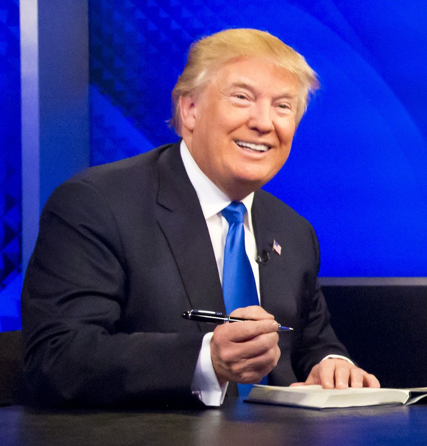 Republican presidential candidate Donald Trump prepares to sign his book during his appearance on Fox&#039;s news talk show &quot;The O&#039;Reilly Factor,&quot; Friday, Nov. 6, 2015, in New York. The ...