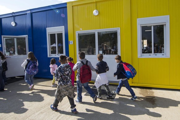 epa05537689 School children arrive to their newly-build makeshift school in Amatrice, Italy, 13 September 2016. Trento Region build a new school for the quake victims to start the new educational year ...