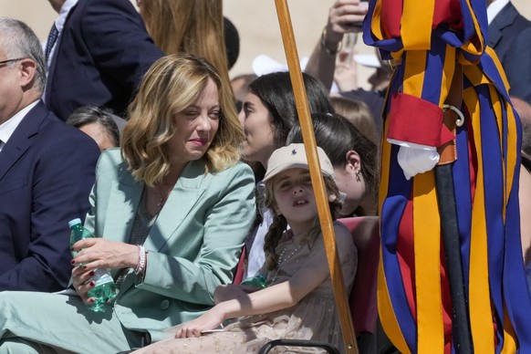 Italian Premier Giorgia Meloni, left, talks to her daughter Ginevra as they attend a mass presided by Pope Francis for the World Children Day, in St.Peter&#039;s Square at the Vatican, Sunday, May 26, ...