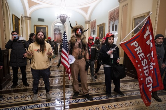 epa09664285 (14/24) (FILE) - Supporters of US President Trump stand by the door to the Senate chambers after they breached the US Capitol security in Washington, DC, USA, 06 January 2021 (reissued 03  ...