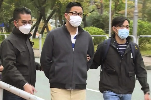 In this image taken from a video, Hong Kong&#039;s Democratic Party member and former lawmaker Lam Cheuk-ting, center, is arrested by police officers at his home in Hong Kong, Wednesday, Jan. 6, 2021. ...