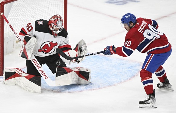 New Jersey Devils goaltender Akira Schmid stops Montreal Canadiens&#039; Anthony Richard during the first period of an NHL hockey game Saturday, March 11, 2023, in Montreal. (Graham Hughes/The Canadia ...