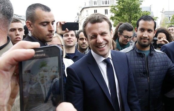 epa06897630 (FILE) - The then French presidential candidate Emmanuel Macron (C) of the &#039;En Marche&#039; political movement flanked by security staff Alexandre Benalla (R) during an election campa ...