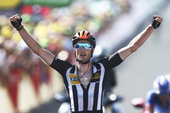 Britain&#039;s Stephen Cummings, wearing an orange helmet to mark Nelson Mandela&#039;s birthday, celebrates a she crosses the finish line to win the fourteenth stage of the Tour de France cycling rac ...
