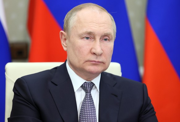 epa10031903 Russian President Vladimir Putin attends a BRICS Plus session involving the leaders of several invited states during the 14th BRICS summit in virtual format, via a video call at the Novo-O ...