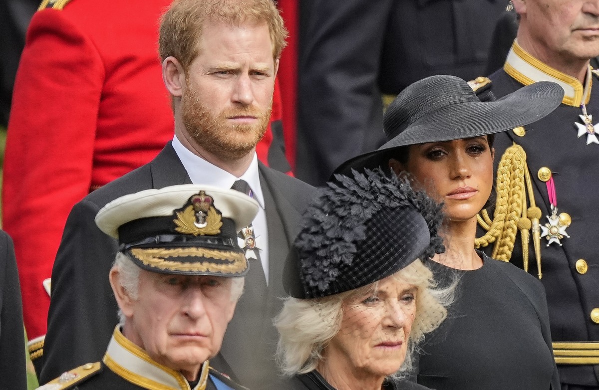 Britain's King Charles III, from bottom left, Camilla, the Queen Consort, Prince Harry and Meghan, Duchess of Sussex watch as the coffin of Queen Elizabeth II is placed into the hearse following  ...