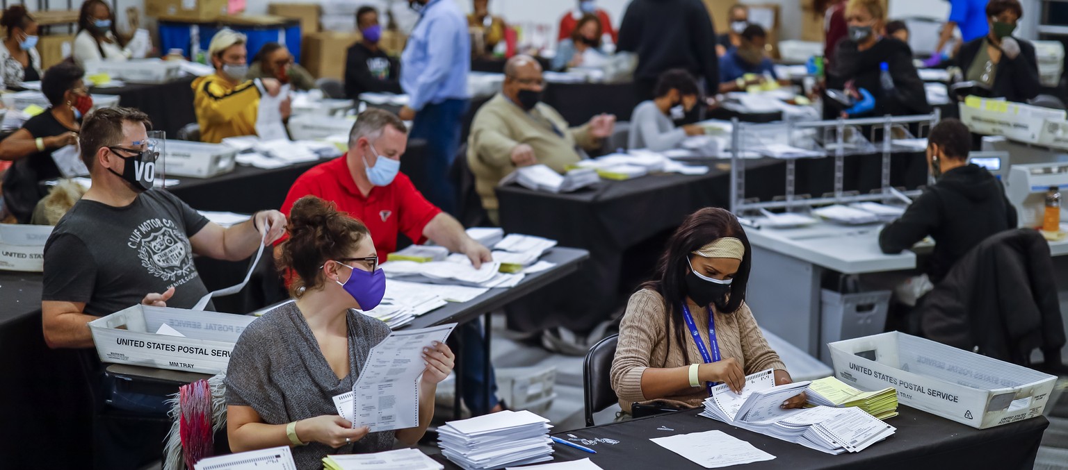 epaselect epa08799668 Absentee ballots are processed and verified by the Fulton County Registration and Elections Department in a large room at State Farm Arena in Atlanta, Georgia, USA, 04 November 2 ...