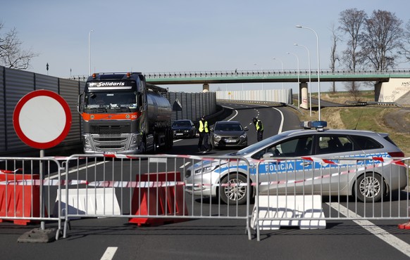 Polish policemen talk to drivers at the closed border crossing near Hradek nad Nisou, Czech Republic, Sunday, March 15, 2020. Due to the outbreak of the novel coronavirus, Poland has imposed more rest ...