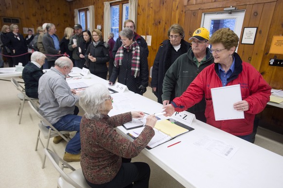epa05151359 People queue to vote in the New Hampshire primary, at a polling station in Laconia, New Hampshire, USA, 09 February 2016. New Hampshire holds the first primary in the United States Preside ...