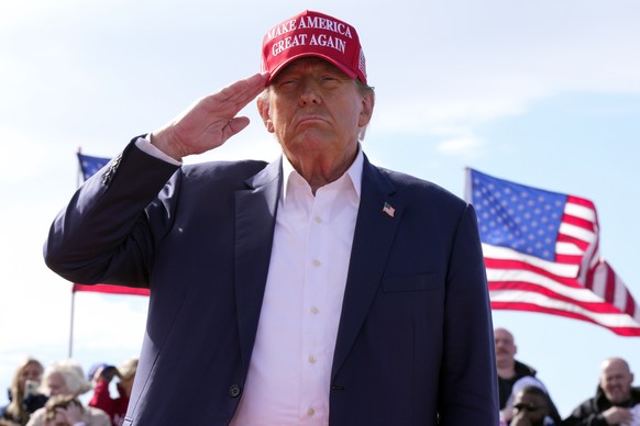 FILE - Republican presidential candidate former President Donald Trump salutes at a campaign rally March 16, 2024, in Vandalia, Ohio. Trump is making the Jan. 6, 2021 attack on the Capitol a cornersto ...