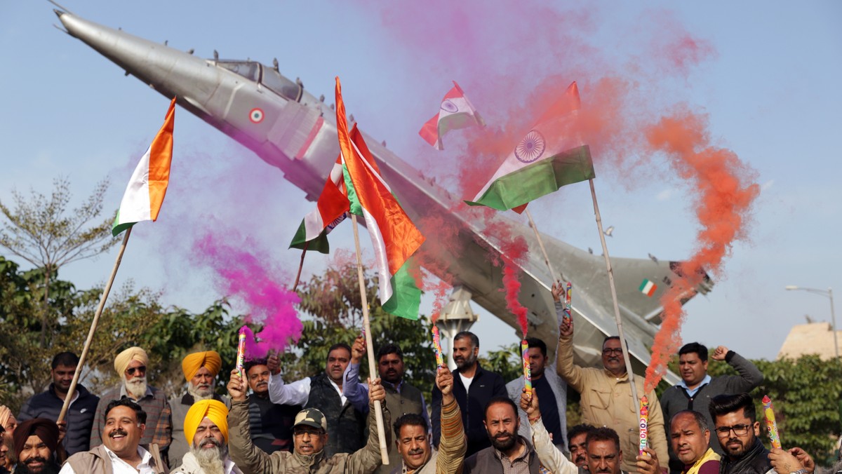 epa07398537 Bhartiya Janta Party (BJP) workers hold Indian flags as they celebrate the Indian Air Force's air strike across the Line of Control (LoC) near the international border with Pakistan,  ...