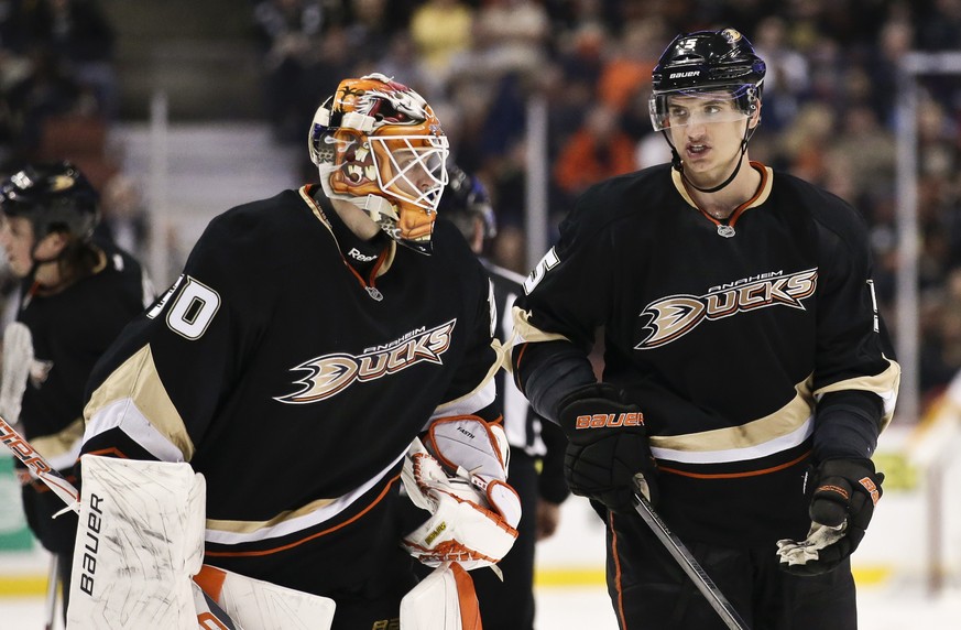 FILE - In this Feb. 28, 2013, file photo, Anaheim Ducks goalie Viktor Fasth, left, talks with defenseman Luca Sbisa during an NHL hockey game against the Nashville Predators in Anaheim, Calif. The Ana ...