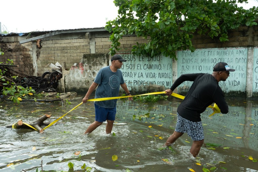 epa10233683 Inhabitants try to clean and fix the damage caused by the passage of Hurricane Julia in San Andres, Colombia, 09 October 2022. Julia was a category one hurricane that left two injured and  ...