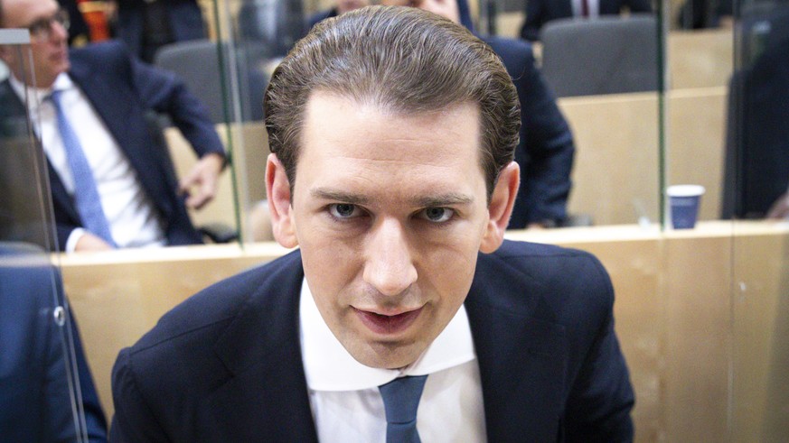 Sebastian Kurz, the former Austrian Chancellor, takes his seat before the sworn-in as deputy in the Austrian Parliament in Vienna, Austria, Thursday, Oct. 14, 2021. (AP Photo/Lisa Leutner)