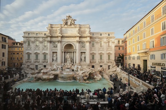 Visitors admire Rome's Trevi Fountain, Friday, Dec. 19, 2025, as the city municipality announced that, starting on Feb. 1, it will impose a 2 euro fee for tourists to get close to the fountain. ( ...
