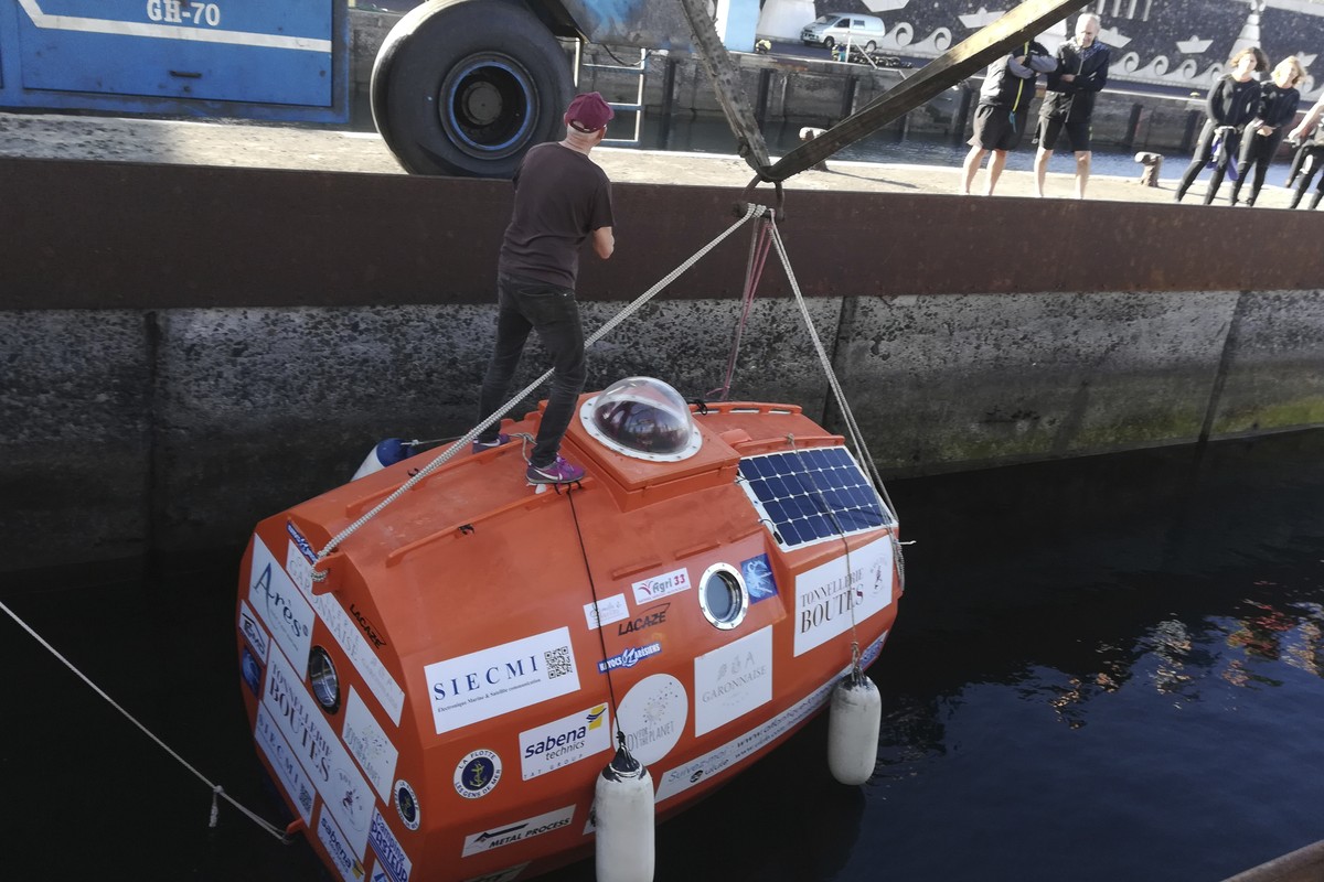 In this photograph taken Saturday Dec. 22, 2018, Frenchman Jean-Jacques Savin, 71-year-old, stands ontop of his 3-metre (10-foot) long, 2.1-metre (7-foot) wide resin-coated plywood capsule, which will ...