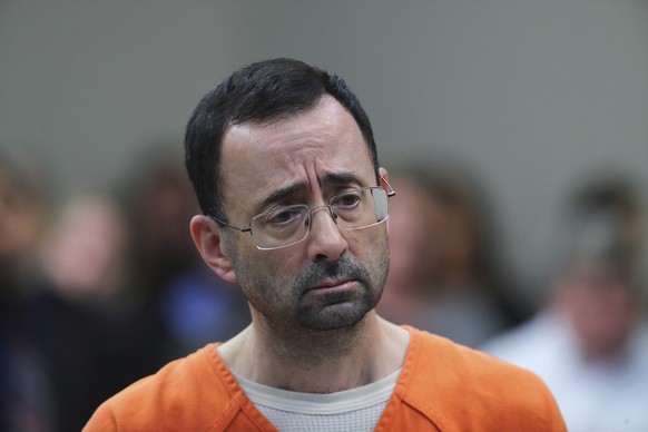 CORRECTS FROM CONVICTED TO SENTENCED - FILE - In this Nov. 22, 2017, file photo, Dr. Larry Nassar, 54, appears in court for a plea hearing in Lansing, Mich. Nassar was sentenced to decades in prison f ...