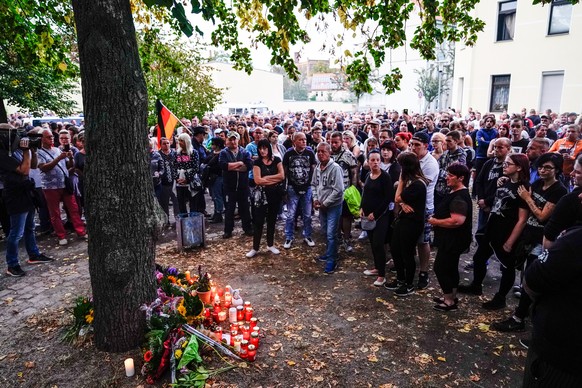 epa07008428 Right wing protesters gather at crime scene where a severely injured man was found in Koethen, Germany, 09 September 2018. On the night of 08 September to 09 September 2018, a 22-year-old  ...