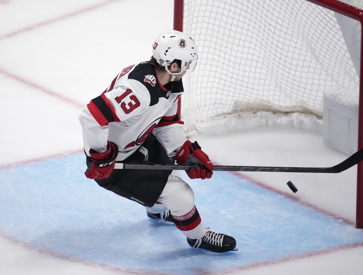New Jersey Devils center Nico Hischier scores an empty-net goal against the Colorado Avalanche during the third period of an NHL hockey game Wednesday, March 1, 2023, in Denver. (AP Photo/David Zalubo ...