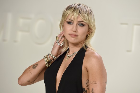 FILE - Miley Cyrus attends the Tom Ford fashion show in Los Angeles on Feb. 7, 2020. Cyrus? ?Endless Summer Vacation? is up for album of the year and best pop vocal album. The single ?Flowers? is nomi ...