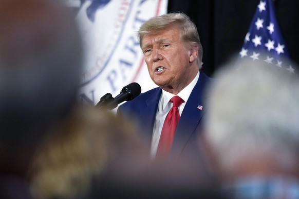 FILE - Former President Donald Trump visits with campaign volunteers at the Elks Lodge, July 18, 2023, in Cedar Rapids, Iowa. A federal judge in Florida has set a trial date for next May for former Pr ...