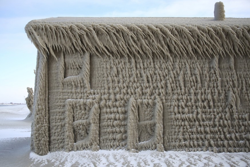 A house along Hoover Beach is covered by ice from high winds, Saturday, Feb. 29, 2020, in Hamburg N.Y. Blowing snow has fallen around the state since Thursday, though the heaviest snowfall was concent ...