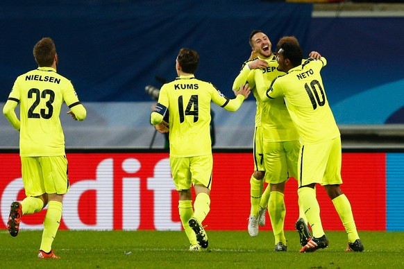 GHENT, BELGIUM - DECEMBER 09: Laurent Depoitre of Gent celebrates scoring his teams first goal of the game with teammates during the group H UEFA Champions League match between KAA Gent and Football C ...