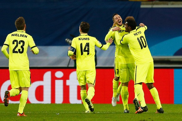 GHENT, BELGIUM - DECEMBER 09: Laurent Depoitre of Gent celebrates scoring his teams first goal of the game with teammates during the group H UEFA Champions League match between KAA Gent and Football C ...