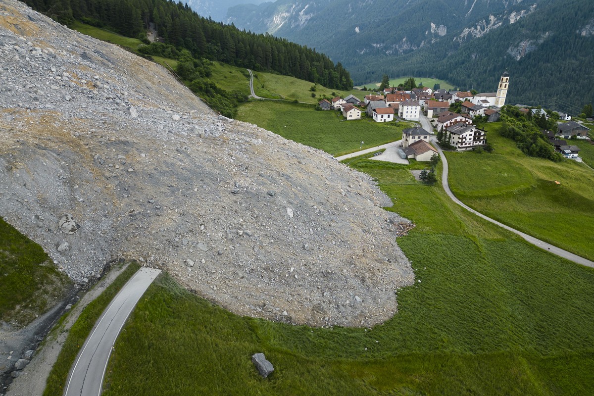 epa10695074 An aerial view shows a road covered with the rockfall 'Brienzer Rutsch' at the village of Brienz-Brinzauls, Grisons canton, Switzerland, 16 June 2023. Overnight 16 June a large p ...