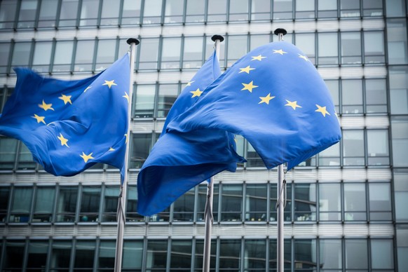 &quot;European flags in front of the European Commission headquarters in Brussels, Belgium. ( Motion Blurred on flags)&quot;