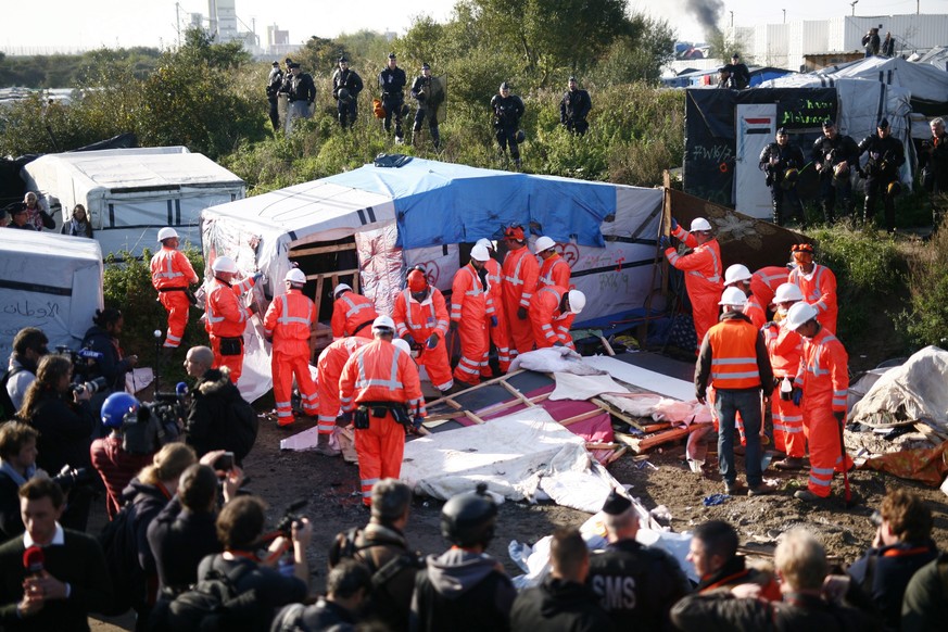 epa05602431 Workers start dismantling makeshift structures at the refugee camp known as the &#039;Jungle&#039; in Calais, France, 25 October 2016. French authorities continued to clear the migrant mak ...