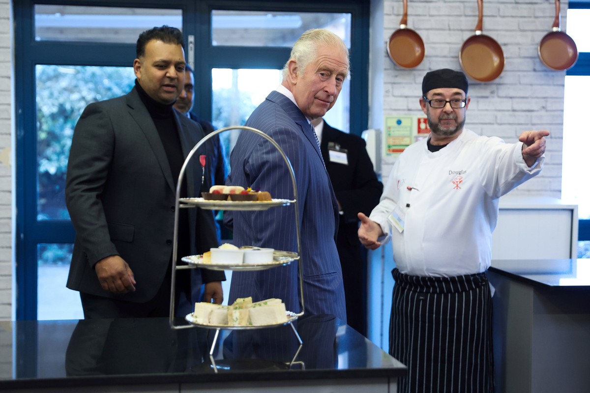Britain's King Charles III meets volunteers and members of staff during a visit to London's Community Kitchen facilities, in Harrow, Greater London, Thursday, Dec. 15, 2022. London's Co ...