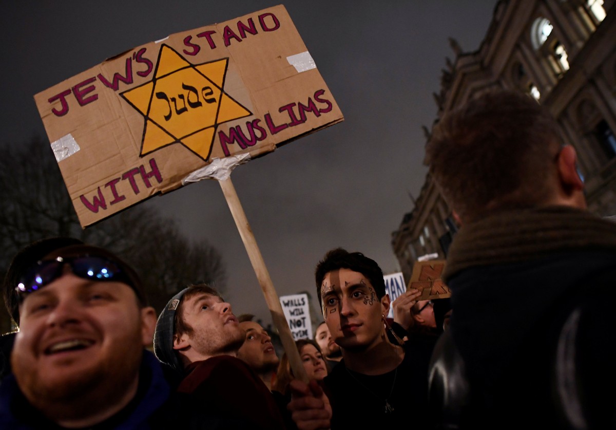 Demonstrators hold placards during a protest against U.S. President Donald Trump's executive order travel ban in London, Britain January 30, 2017. REUTERS/Dylan Martinez