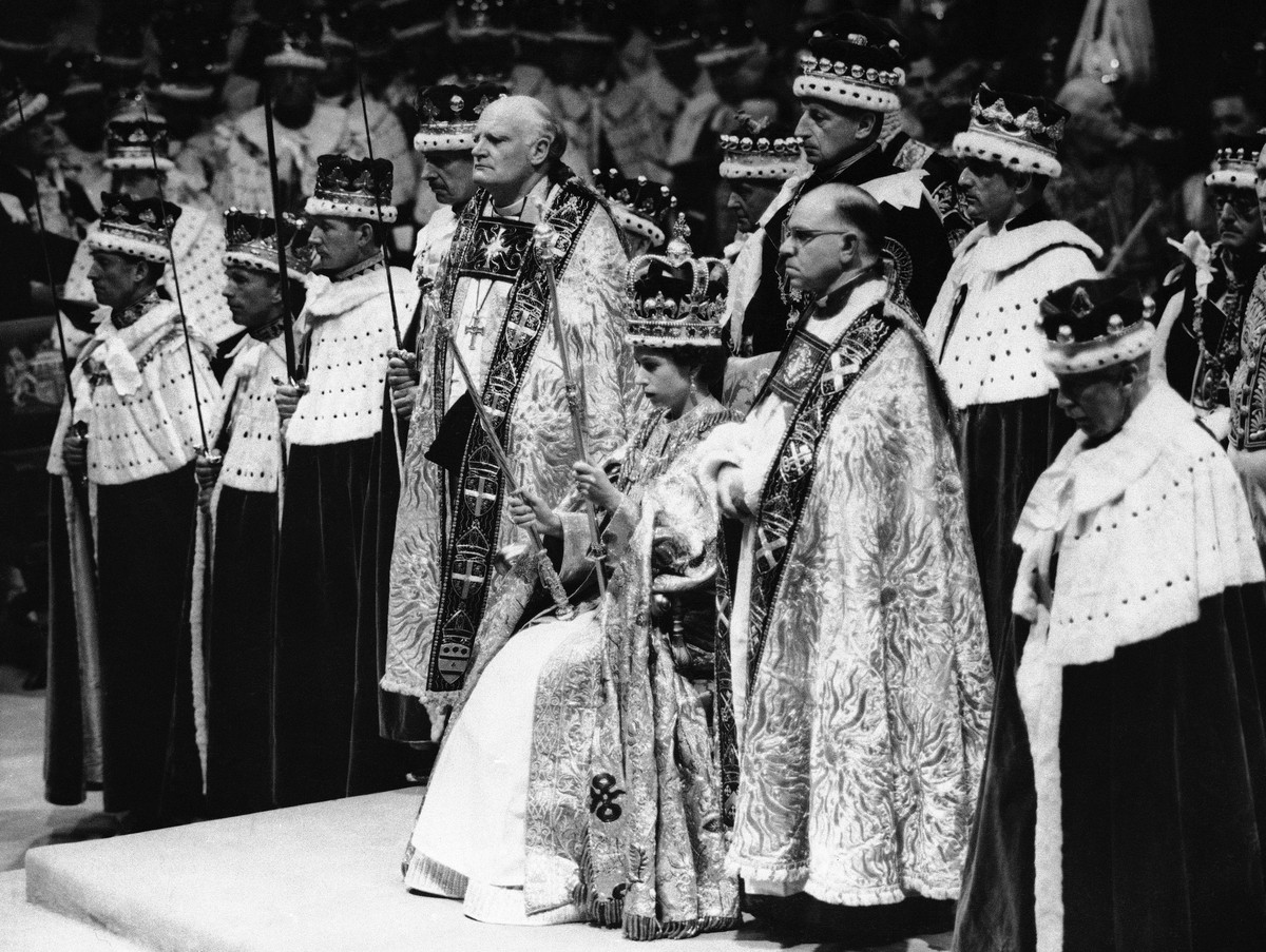 FILE - Britain's Queen Elizabeth II is crowned the Monarch of Britain holding the Royal Scepter, sat on throne, wearing St. Edward's crown, at Westminster Abbey, in London, June 2, 1953. St. ...