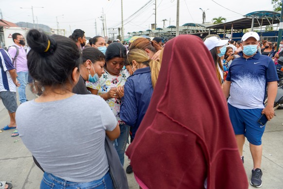 epa09580502 Relatives of prisoners await information about their loved ones, outside the penitentiary of Guayaquil, Ecuador, 13 November 2021. A total of 58 inmates died and another 12 were injured in ...