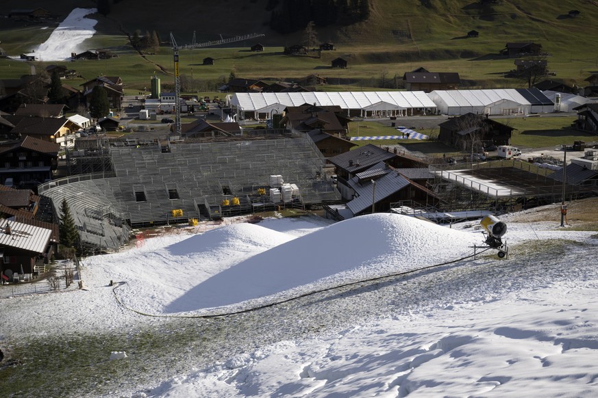 A snow canon and the artificial snow are photographed close to the finish area under construction of the the Alpine Skiing FIS Ski World Cup, at Adelboden, Switzerland, Wednesday, December 28, 2022.Th ...