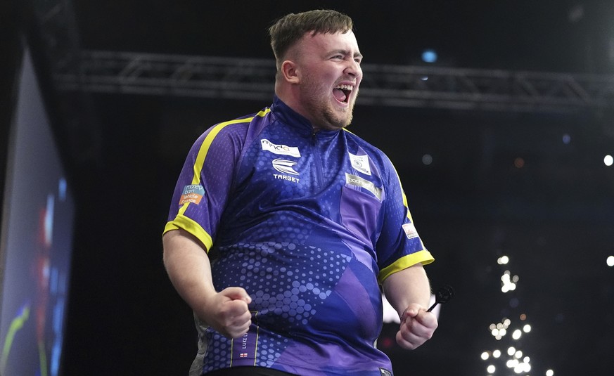 Luke Littler celebrates victory in the final against Luke Humphries during the Darts Premier League play-off at The O2, London, Thursday, May 23, 2024. (Zac Goodwin/PA via AP)