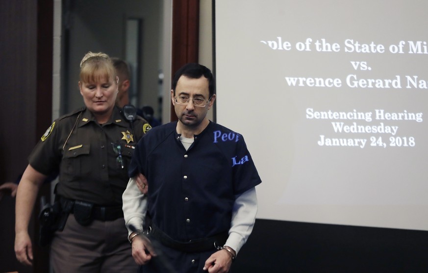 Dr. Larry Nassar is escorted into court during the seventh day of his sentencing hearing Wednesday, Jan. 24, 2018, in Lansing, Mich. Nassar has admitted sexually assaulting athletes when he was employ ...