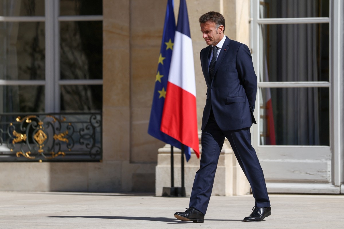 epa12874869 French President Emmanuel Macron walks to greet Cecile Kohler and Jacques Paris, two French nationals freed by Iran after three and a half years in detention, at the Elysee Palace in Paris ...